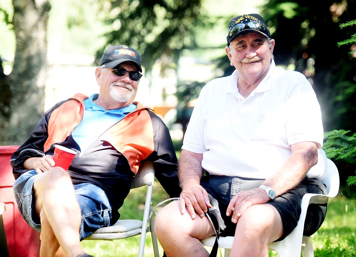 James Cooper &#147;Coop&#148;, left, and James Williamson &#147;Big Will&#148; share a smile as they watch some of their fellow Marines joke and tell stories at their reunion on Sunday, June 24, in Columbia Falls.(Brenda Ahearn/Daily Inter Lake)