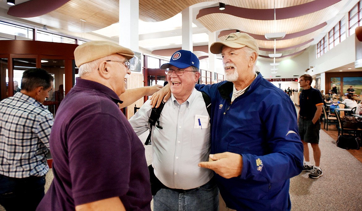 John DeNardo &#147;JD&#148; left, and Michael Jaworsky &#147;Ski&#148; gather at the Glacier Park International Airport to meet Tim Donovan as he arrives for their reunion in Columbia Falls.