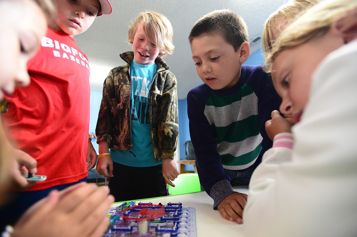 First- and second-graders work on an electronic snap circuits project at Bigfork ACES summer camp.