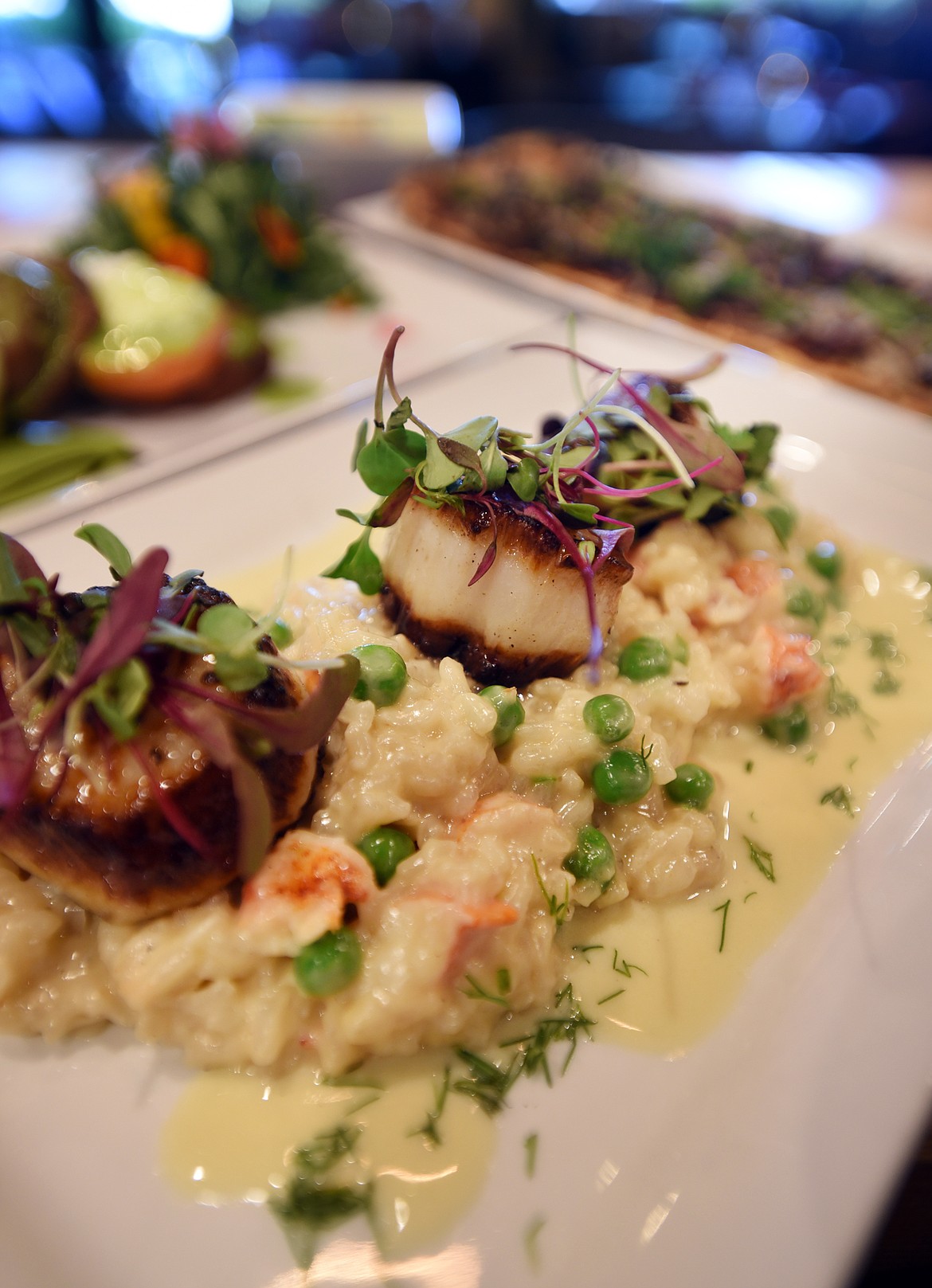 A collection of dishes at Beargrass Bistro in Lakeside including the &quot;Boston Day Boat&quot; which consists of jumbo scallops with fresh Main lobster and pea risotto, and lemon dill beurre blanc.(Brenda Ahearn/Daily Inter Lake)