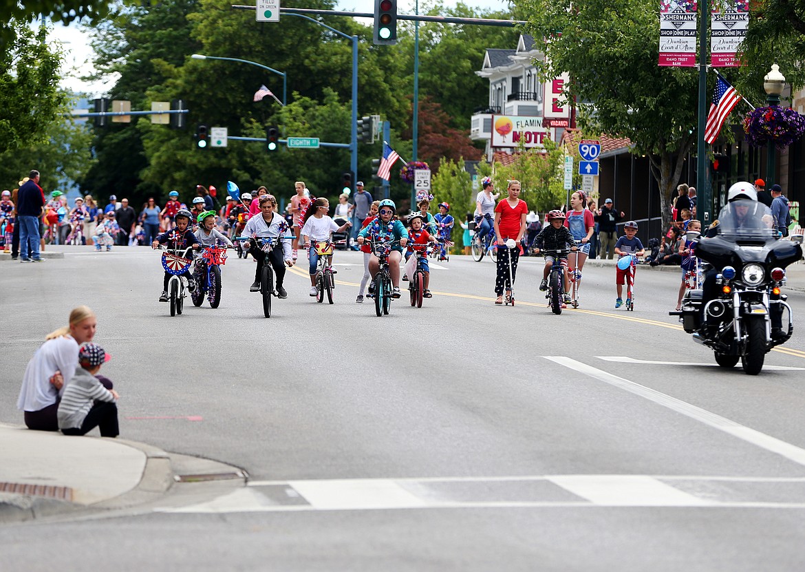 Kids ride their bikes down Sherman Avenue during Coeur d'Alene's Kids Parade on Tuesday. (LOREN BENOIT/Press)