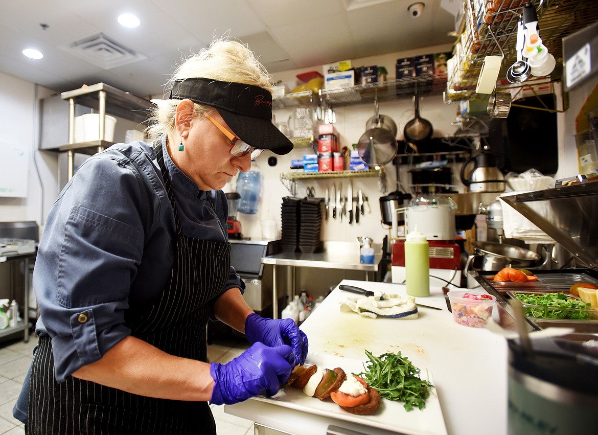 Cece Andersson, the executive chef at Beargrass Bistro, puts together her personal version of a caprese salad which adds fried eggplant to the traditional tomatoes and mozzarella cheese.(Brenda Ahearn/Daily Inter Lake)