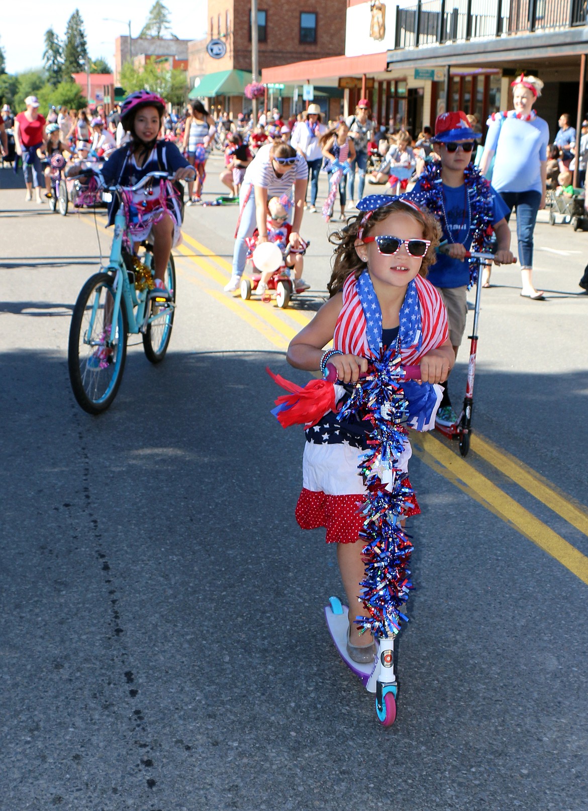 (Photo by CAROLINE LOBSINGER)A youngster takes part in the Kids Parade to kick off the Fourth of July fun. The parade is the first of two parades put on by the Sandpoint Lions Club to celebrate America's independence.