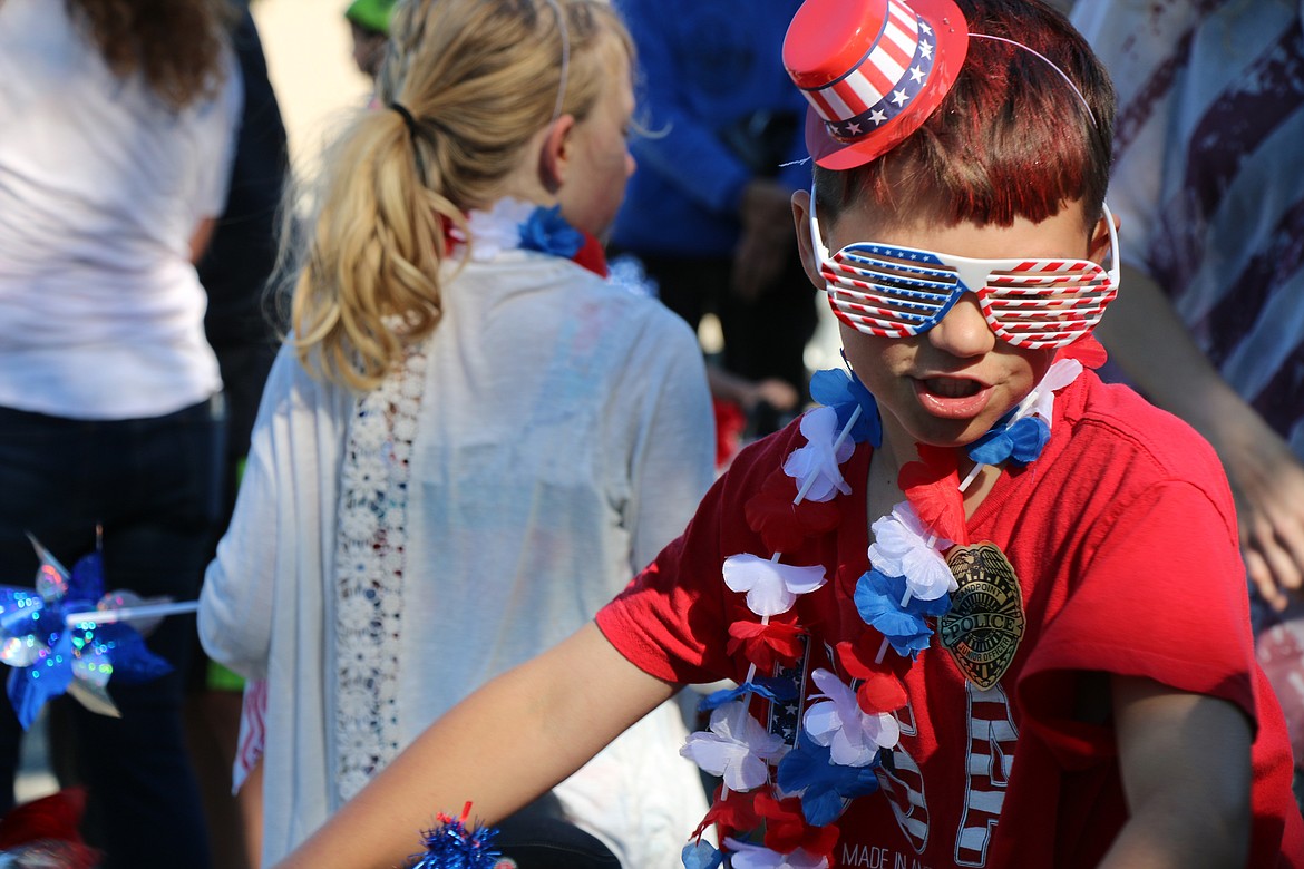 (Photo by CAROLINE LOBSINGER)A young parade participant waits for the start of the Sandpoint Lions' Kids Parade Wednesday on the Fourth of July.