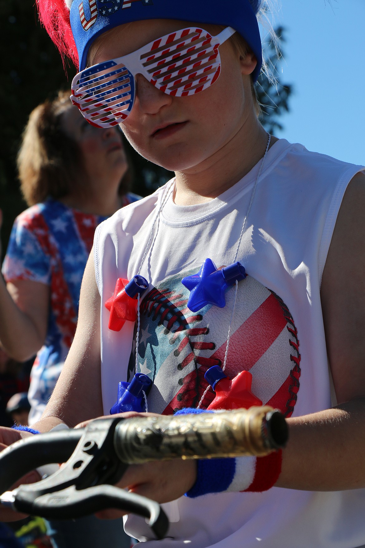 (Photo by CAROLINE LOBSINGER)Mason Shaffer of Sandpoint puts the finishing touches on his patriotic garb as the Sandpoint Lions' Kids Parade gets set to start Wednesday on the Fourth of July.