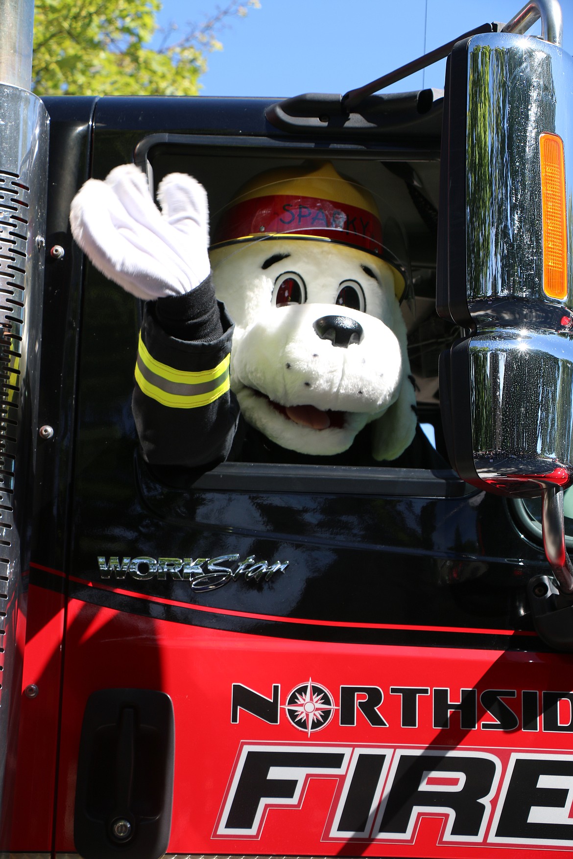 (Photo by CAROLINE LOBSINGER)Sparky the Fire Dog rides in a Northside Fire truck during the Sandpoint Lions' Grand Parade on the Fourth of July Wednesday.