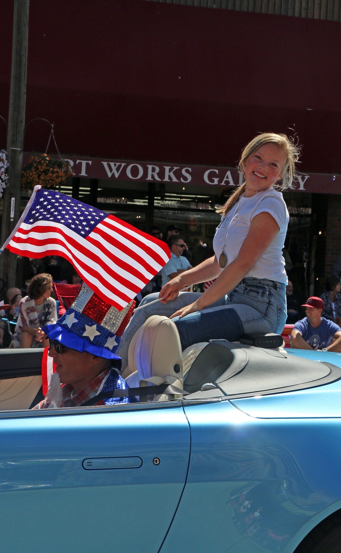 (Photo by CAROLINE LOBSINGER)Sandpoint Distinguished Young Woman Hope Ambridge smiles for the camera as she rides down First Avenue during the Sandpoint Lions' Grand Parade on the Fourth of July on Wednesday.