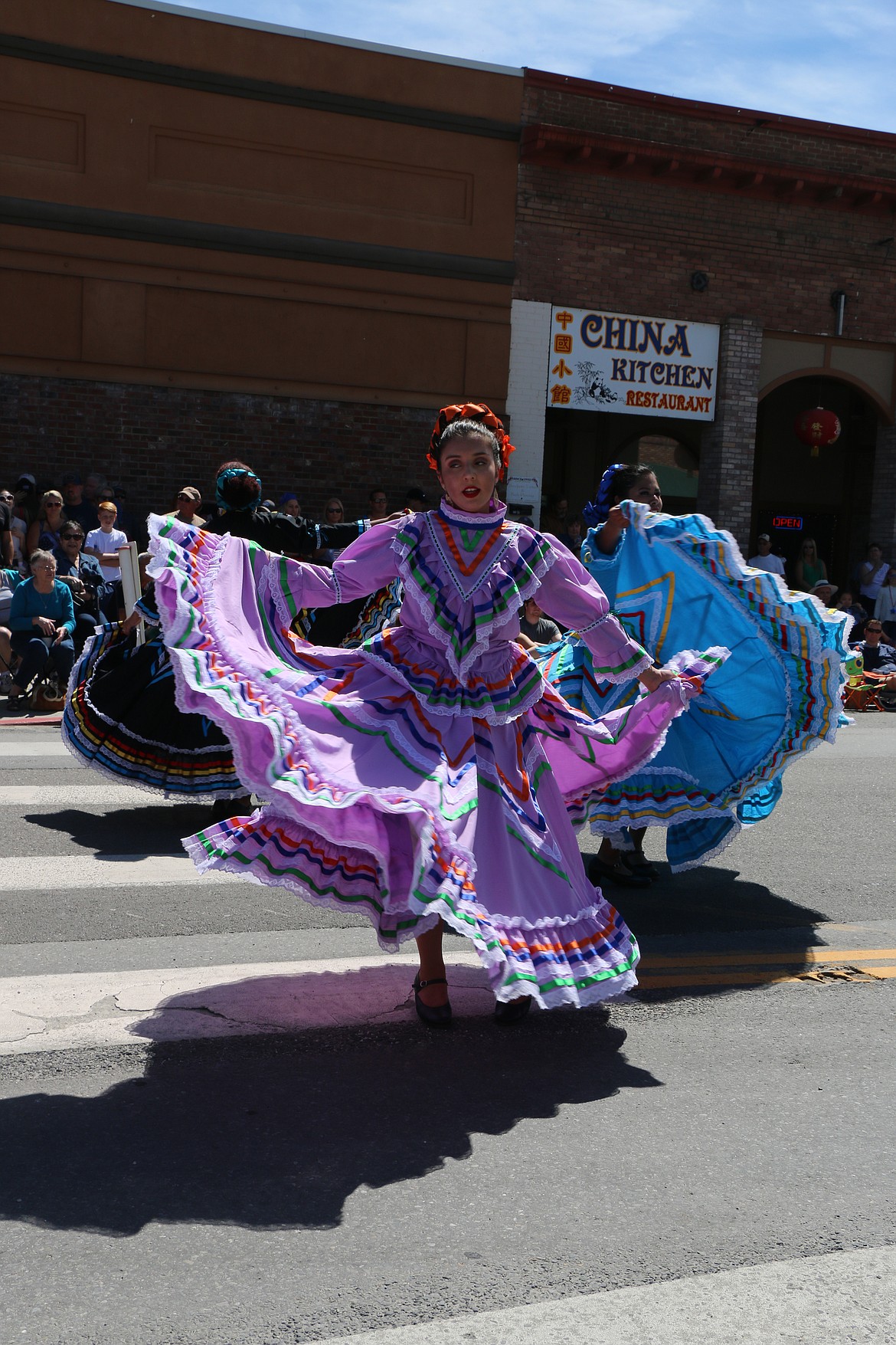 (Photo by CAROLINE LOBSINGER)Dancers perform for the crowd as they take part in the Sandpoint Lions' Grand Parade on the Fourth of July on Wednesday.