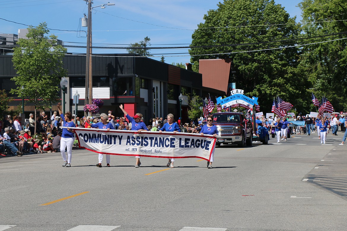 (Photo by CAROLINE LOBSINGER)Community Assistance League members wave to the crowd as they take part in the Sandpoint Lions' Grand Parade on the Fourth of July on Wednesday.