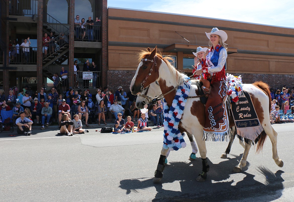 (Photo by CAROLINE LOBSINGER)Members of the Bonner County Rodeo court ride down First Avenue as they take part in the Sandpoint Lions' Grand Parade on the Fourth of July Wednesday.