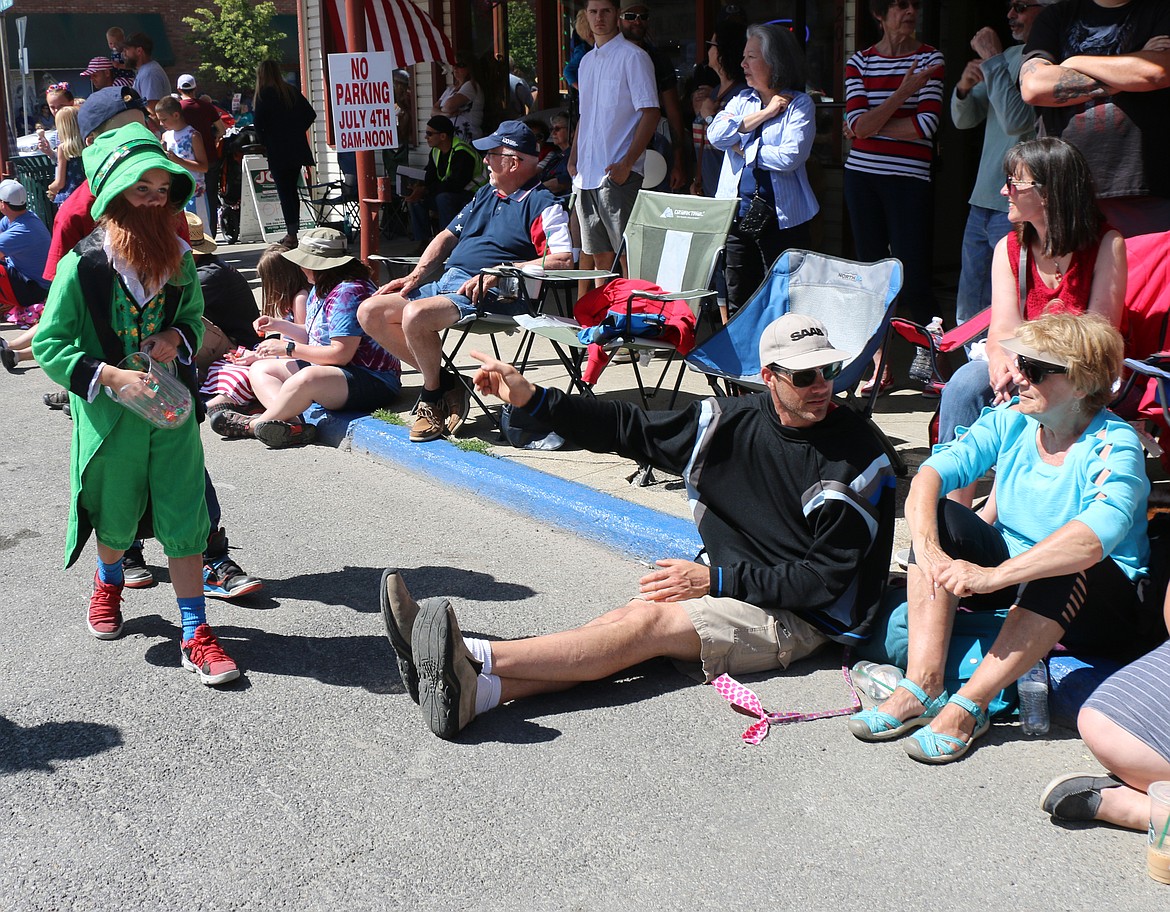 (Photo by CAROLINE LOBSINGER)Members of the MickDuff's Brewing Company's parade entry hand candy out to the crowd as they take part in the Sandpoint Lions' Grand Parade on the Fourth of July on Wednesday.