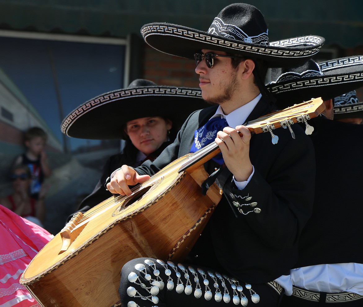 (Photo by CAROLINE LOBSINGER)A mariachi band member plays a song as the Fiesta Bonita float makes its way down First Avenue during the Sandpoint Lions' Grand Parade on the Fourth of July on Wednesday.