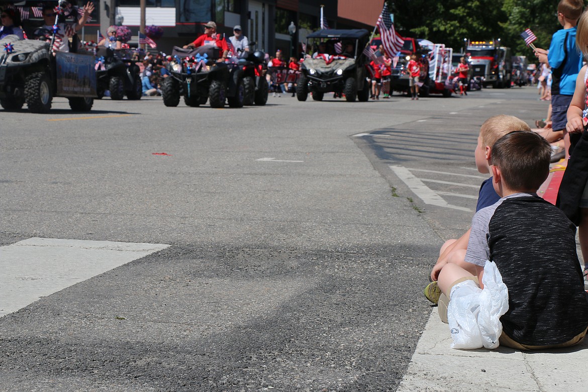 (Photo by CAROLINE LOBSINGER)A pair of parade participants watch the action during the Sandpoint Lions' Grand Parade on the Fourth of July on Wednesday.