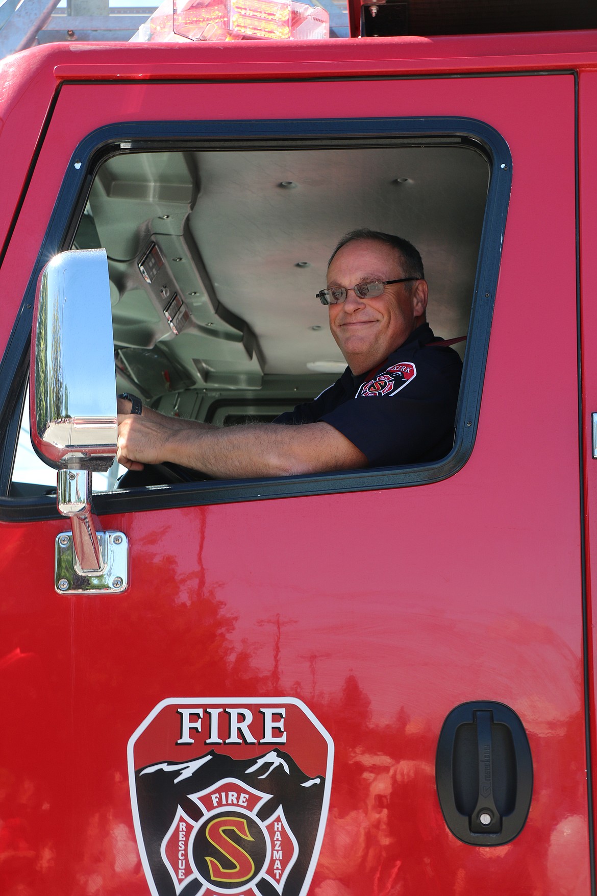 (Photo by CAROLINE LOBSINGER)Selkirk Fire firefighter Bernie Frechette drives a rig down Church Street during the Sandpoint Lions' Grand Parade on the Fourth of July Wednesday.