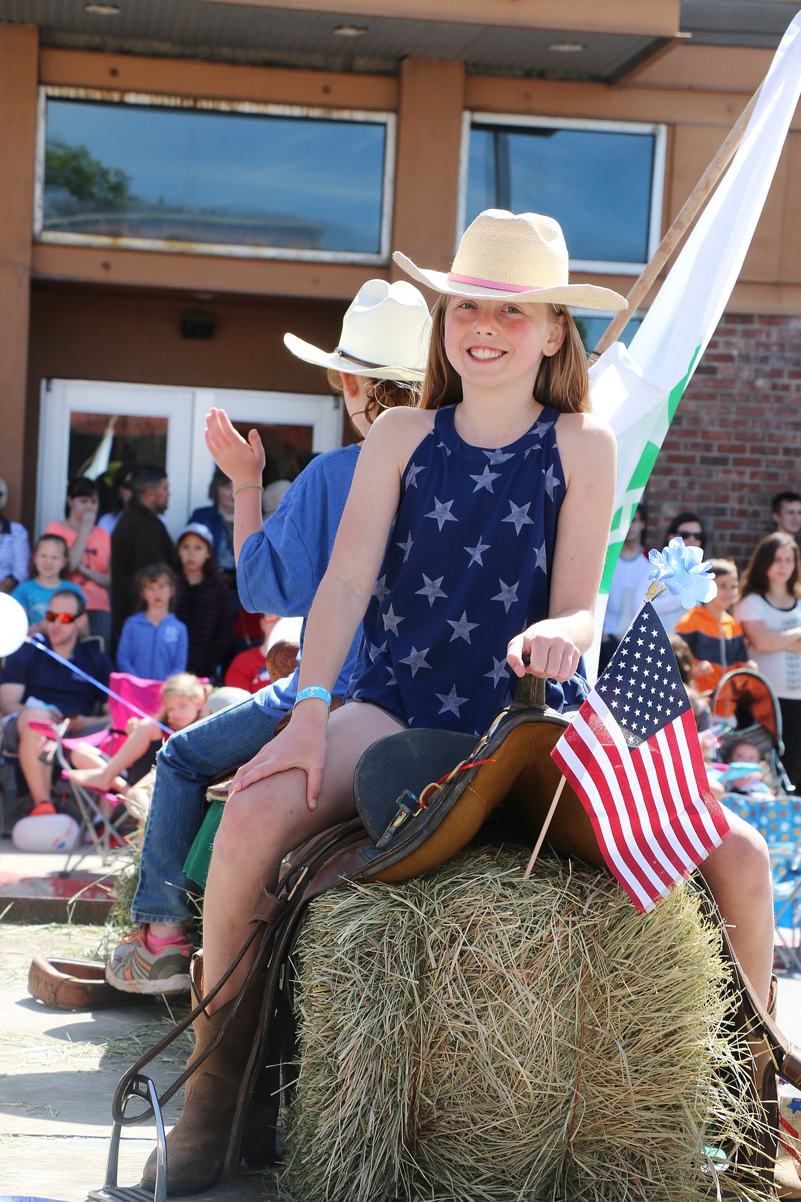 (Photo by CAROLINE LOBSINGER)A 4-H member rides on a float in the Sandpoint Lions' Grand Parade on the Fourth of July on Wednesday.