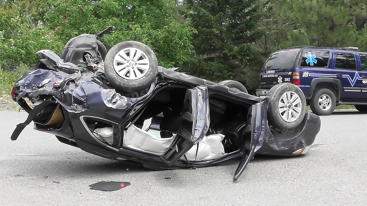 A Subaru Outback rests on its roof on Angel Point Drive near Lakeside after it was involved in a two-car accident Friday afternoon. A witness said the Outback was rear-ended by a BMW 335i on U.S. 93, sending it over an embankment. Two people in the Subaru and one in the Outback were taken to the hospital. (Scott Shindledecker/Daily Inter Lake)