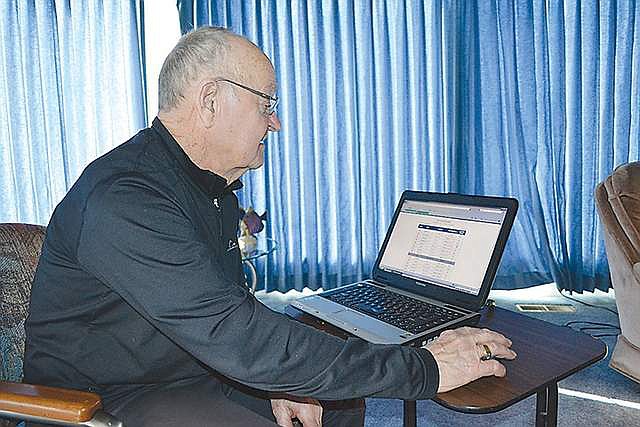 Columbia Basin Herald/file photo
Mel Olson browses through a website back in 2012 that allows users to track the miles they have logged on their bicycle.