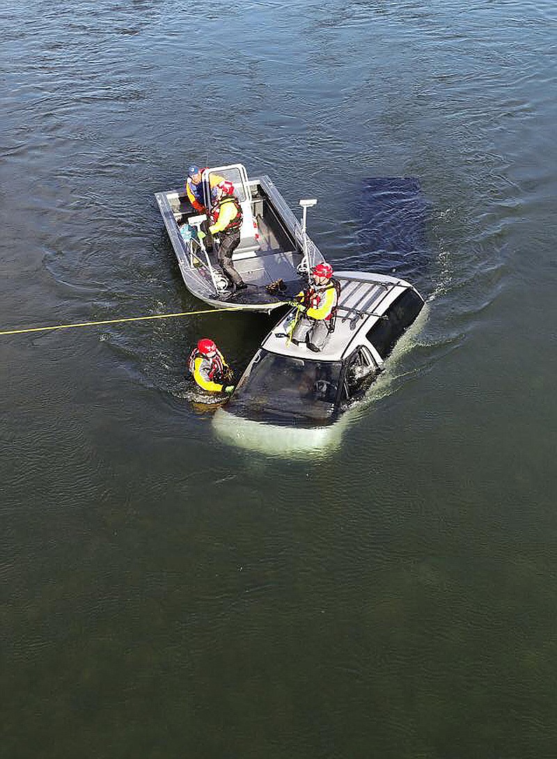 Members of the Flathead County Sheriff Office&#146;s Swiftwater Rescue team prepare a van to be towed from the Flathead River on Monday morning. The van sunk in the river after a man attempted to launch the boat. (Photo from Flathead County Sheriff Office)