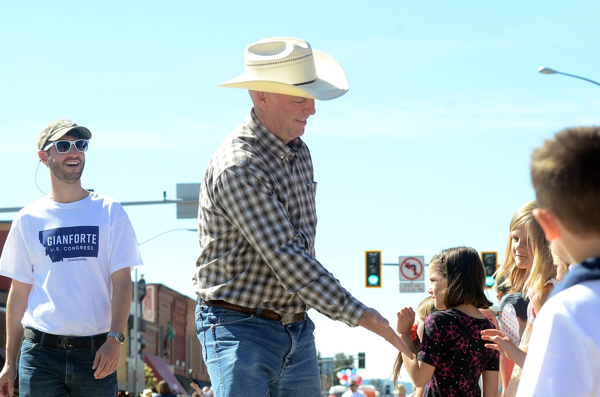 U.S. Rep. Greg Gianforte, R-Mont., greets paradegoers in the Fourth of July parade in Kalispell.