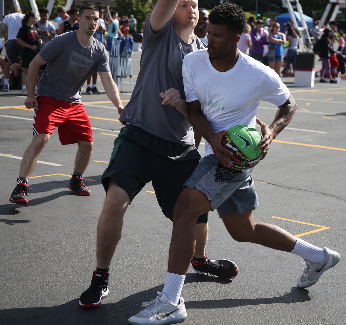 Deon Watson of Super Soakers drives to the basket during an opening-round game at Hoopfest on Saturday in the Spokane Arena parking lot.