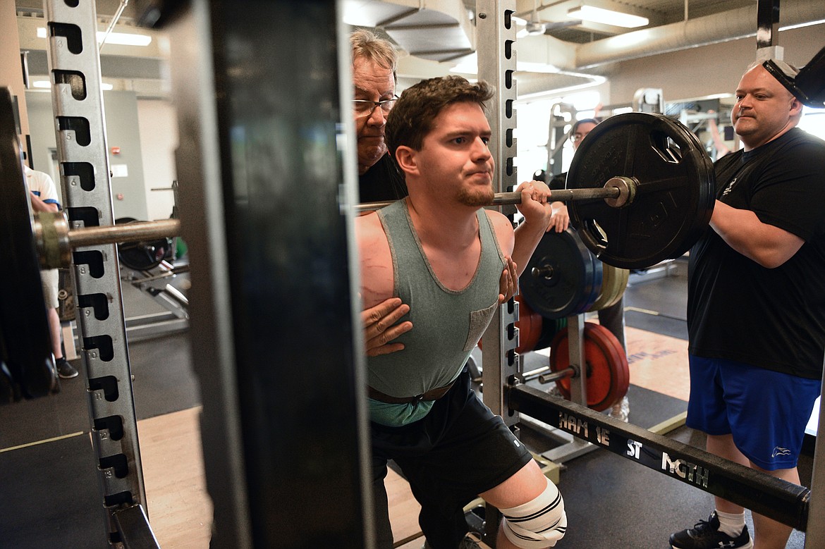 Powerlifter Chandler Krahn is spotted by coach Mark Kuhr during a workout at The Wave Aquatic &amp; Fitness Center in Whitefish on Tuesday, June 26. At right, is assistant coach Rock Henderson. (Casey Kreider/Daily Inter Lake)