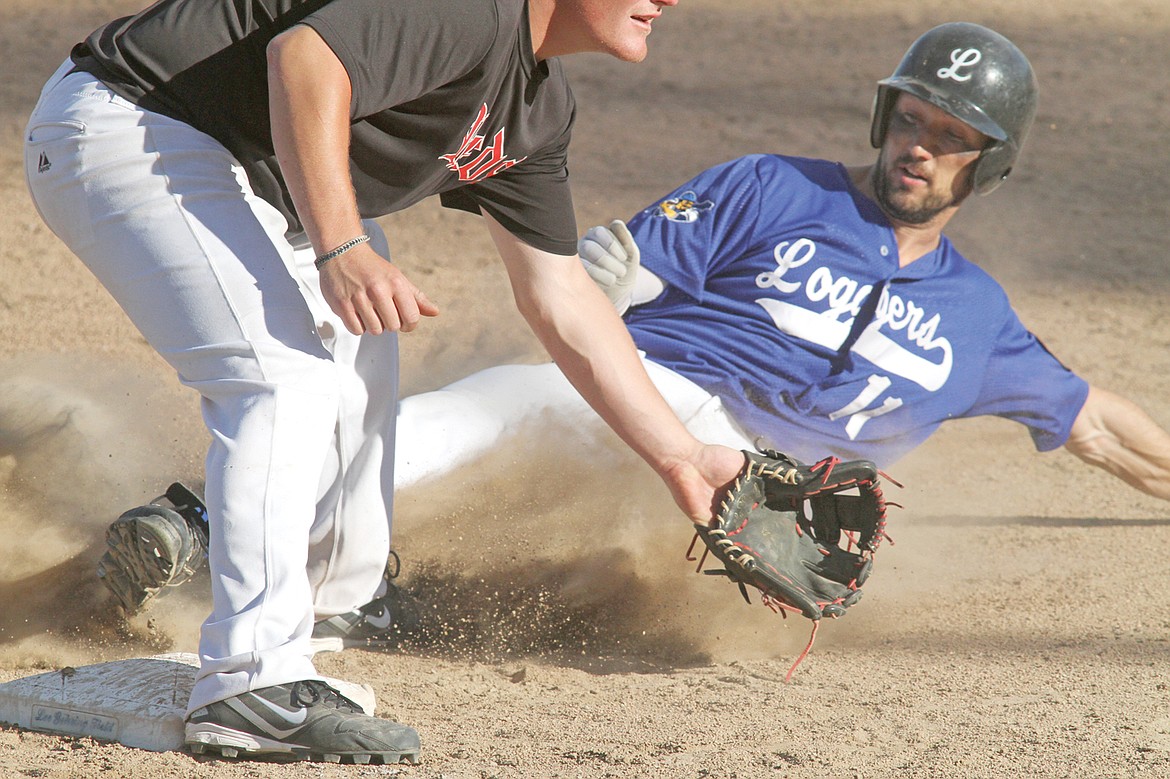 Jake Swartzendruber steals third in the bottom of the fourth inning as the Reds&#146; Gordon Armitage waits for a late throw. (Paul Sievers/The Western News)