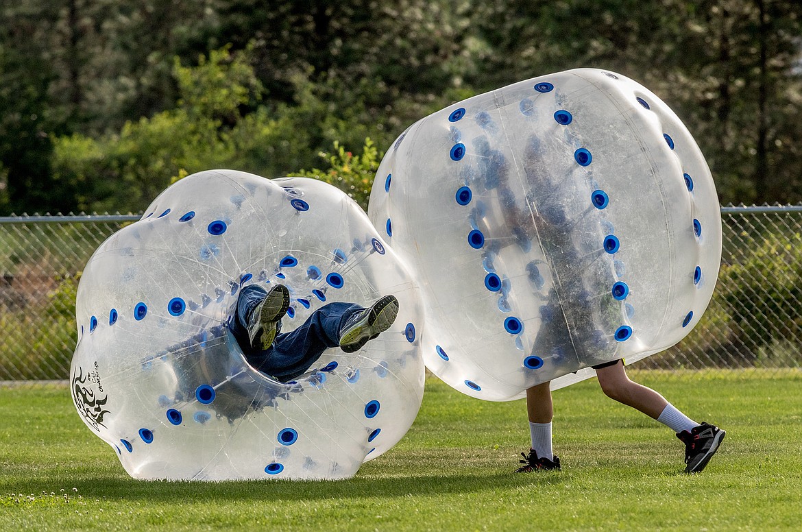 Brothers Jacob Gromley, left, and Matthew Gromley batter one another in inflatable plastic balls in Roosevelt Park during Troy&#146;s Fourth of July celebration. (John Blodgett/The Western News)