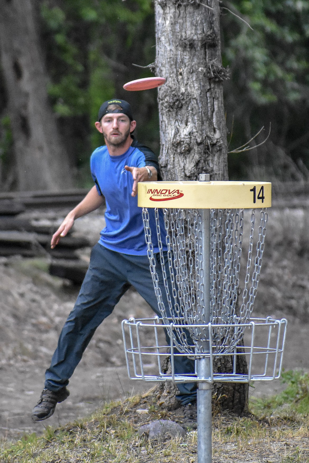 Josh Williamson from Post Falls putts around a tree on the 14th hole during the Timber Beast Disc Golf Tournament on Saturday, June 30. (Ben Kibbey/The Western News)