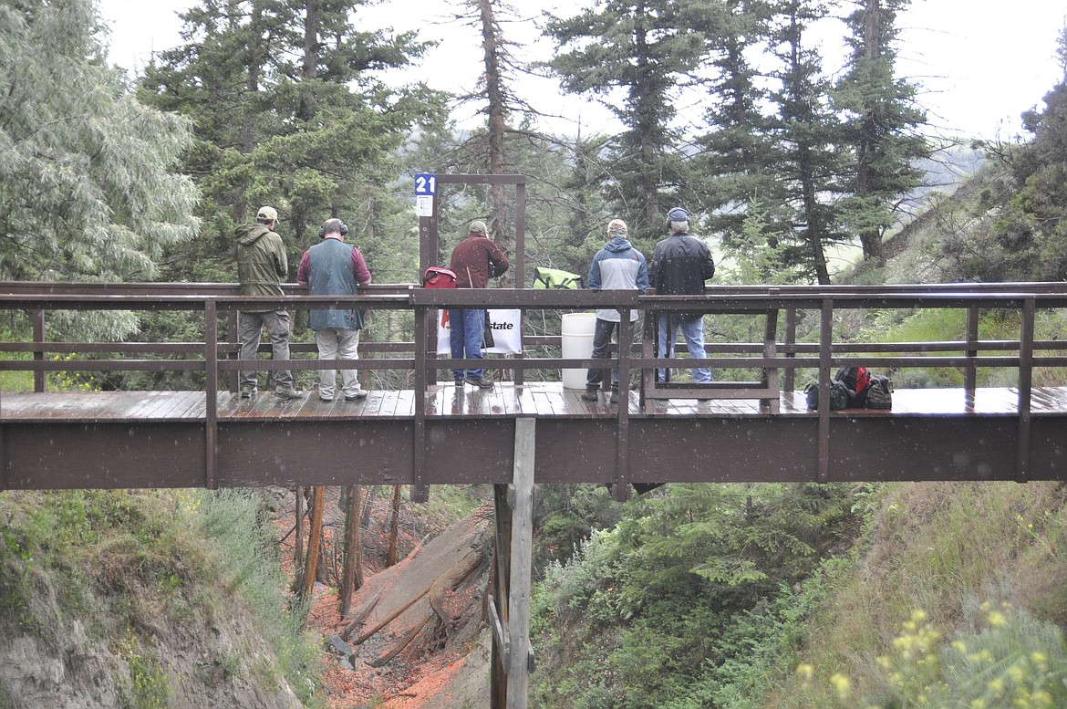 A GROUP of shooters participate in the 7th Annual Chamber Blast event at Big Sky Sporting Clay in the rain. (Ashley Fox/Lake County Leader)