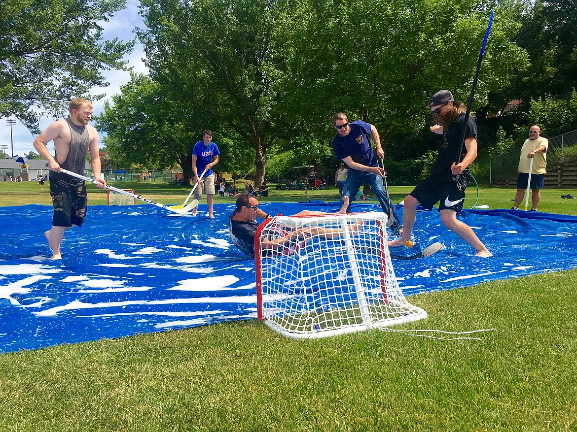 Photo by JONNIE NELSON/ 
(From left) Chanse Watson, Toby Colburn, John Miller, Aaron Cagle and Quintin Kimberling hack and slash their way through a game of soap hockey. This particular game was the firefighter team vs. the Silver Mountain team.