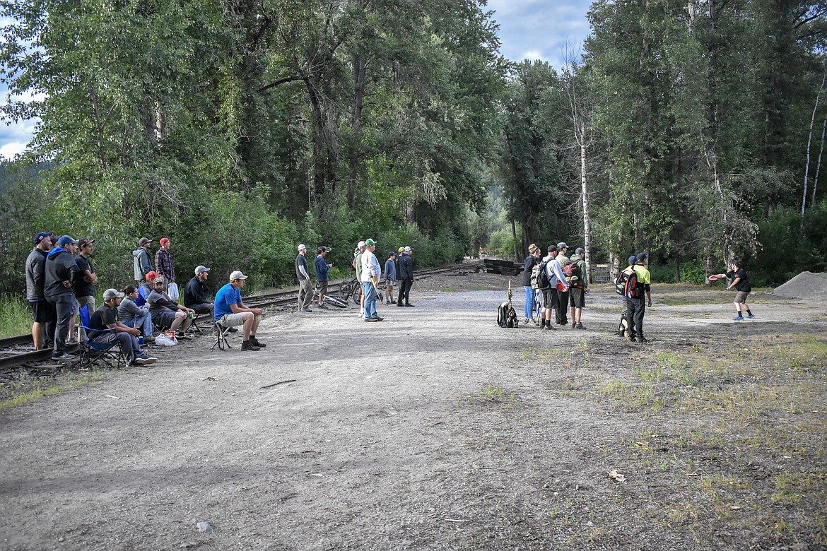 An audience gathered to watch players between the 14th, 15th and 18th holes, adding to those following the pros group during the Timber Beast Disc Golf Tournament on Saturday, June 30. (Ben Kibbey/The Western News)