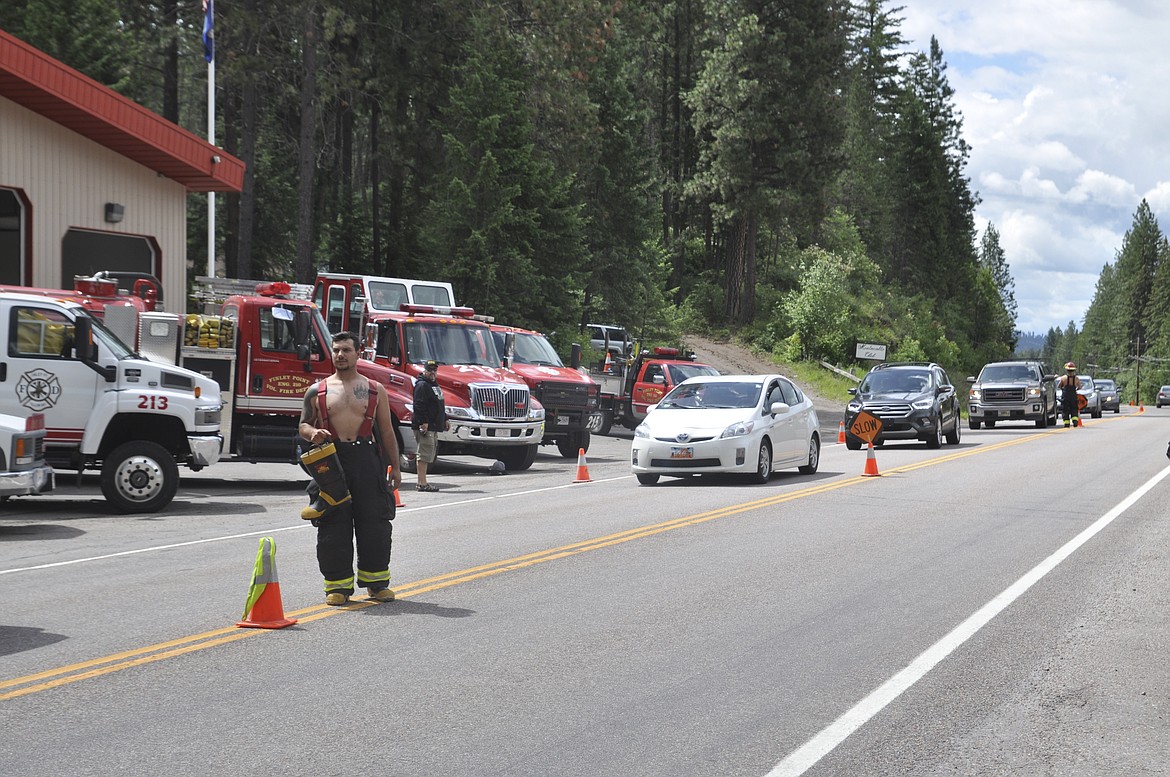 VOLUNTEER FIREFIGHTER Rhett Burland gets ready to welcome a truck through the Finley Point area in front of the area&#146;s fire department Saturday, June 30. (Ashley Fox/Lake County Leader)