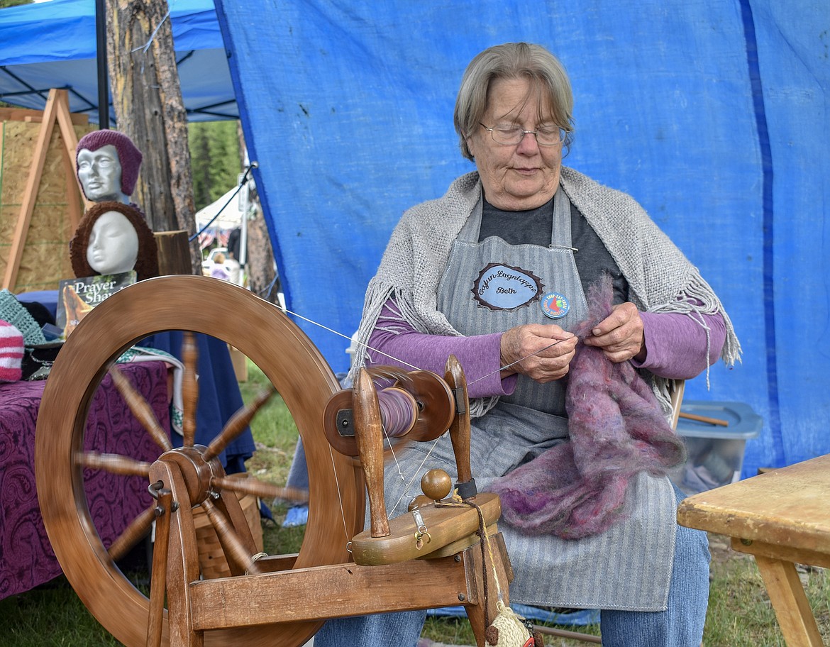 Elizabeth Syron spins wool at her booth during the sixth annual Yaak School Arts and Crafts Fair Saturday, June 30. Syron said she has fun coming to the fair, &#147;It&#146;s the people, it&#146;s the event, it&#146;s helping the school.&#148;
(Ben Kibbey/The Western News)