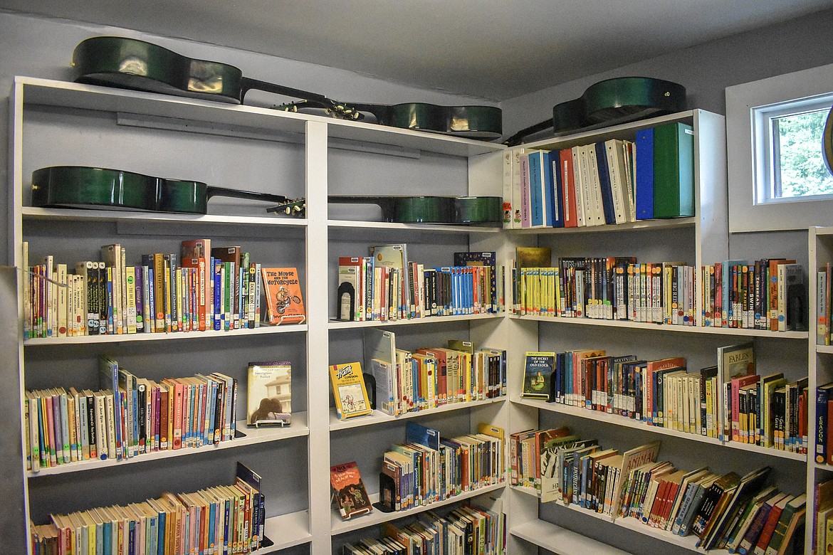 The library at the Yaak School, where students, even those who are homeschooled, can check out books, also has guitars for music lessons. 
(Ben Kibbey/The Western News)