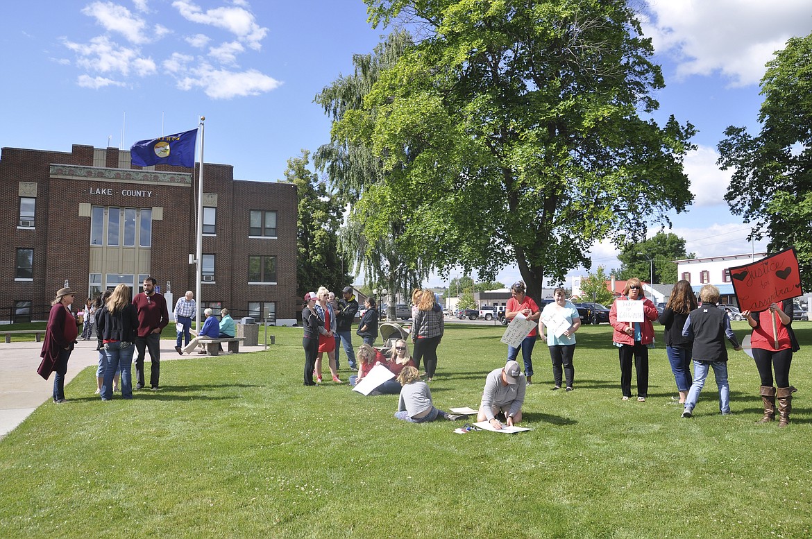 FRIENDS, FAMILY and community members attended a protest Monday morning at the Lake County Courthouse, carrying signs saying &#147;Justice 4 Cassandra,&#148; a woman who died last week. Following the arrest of four suspects, two were released on their own recognizance. (Ashley Fox/Lake County Leader)