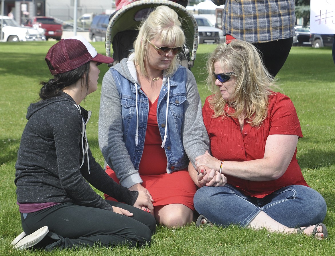 FAMILY MEMBERS of Cassandra Harris comfort each other during a protest on the Lake County Courthouse lawn Monday morning. (Ashley Fox/Lake County Leader)