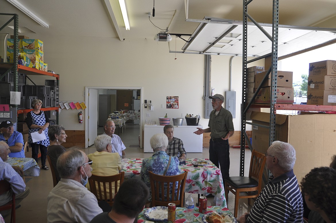 FRIENDS OF Bryan River, right, smile as he talks about his time as the Polson Loaves &amp; Fish manager during a barbecue last week. (Ashley Fox/Lake County Leader)