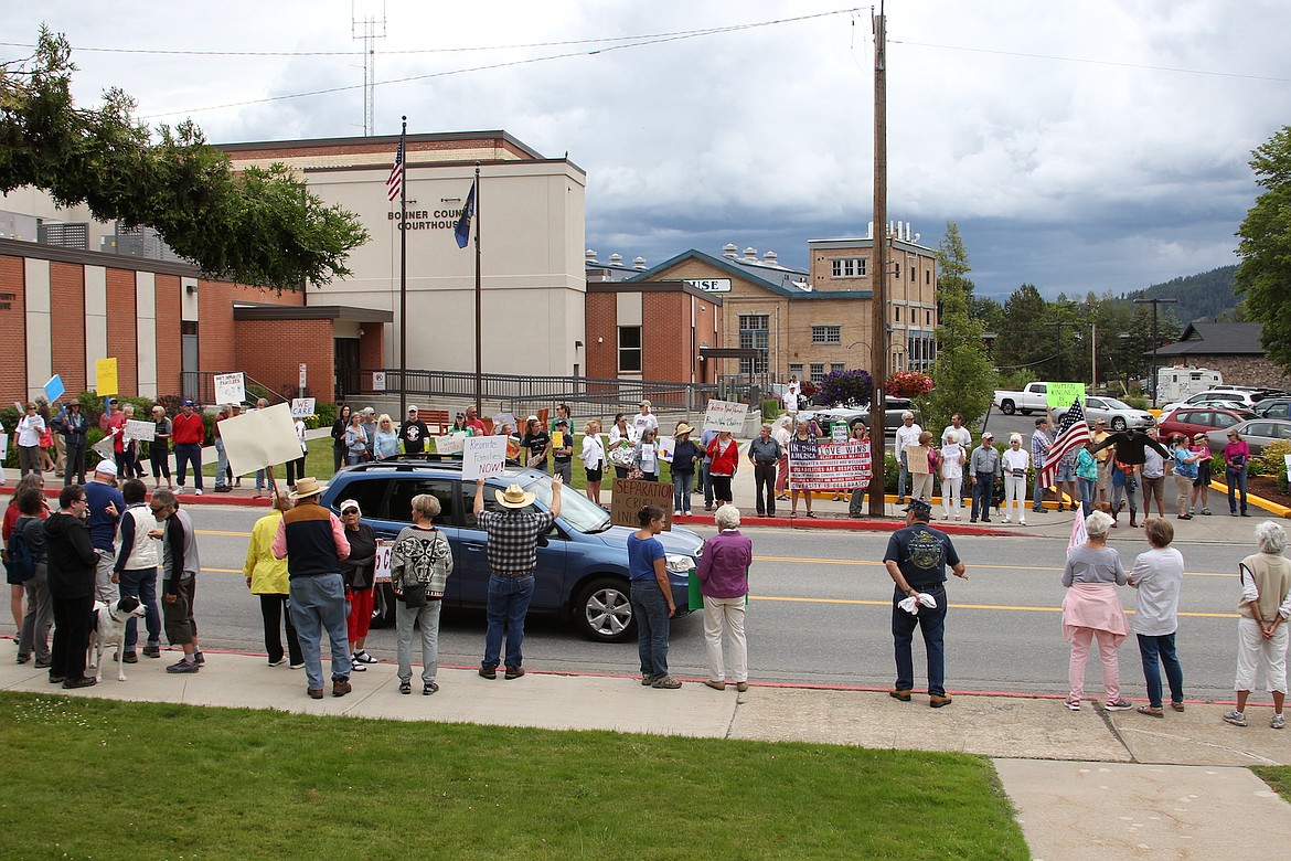 (Photo by KEITH KINNAIRD)
A motorist honks in support of reuniting families separated at the border on Saturday.