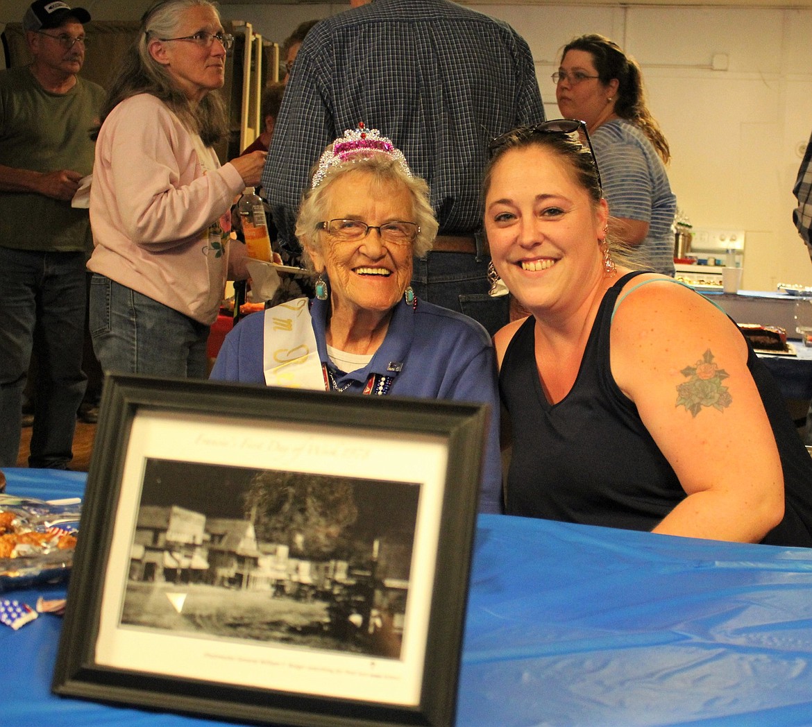 Francis Higgs (left) is retiring from her position as a mail carrier for the U.S. Postal Service. Jen Zimmerman (right) has been hired to take Francis&#146; place. They pose in front of a framed photo which supposedly depicts Fran on her first day of work in 1978 presented by Jim Burwasser.