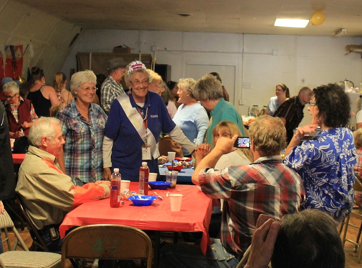 Francis Higgs gives hugs and has her photo taken with friends at her retirement party on Saturday. She has 40 years of service with the U.S. Poster Service.