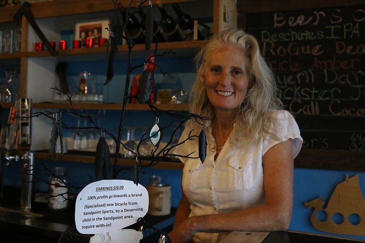 (Photo by MARY MALONE)Sandpoint Sports owner Lisa Campbell is making earrings out of bicycle tire tubes and selling them to purchase a new bikes for deserving children in the community.