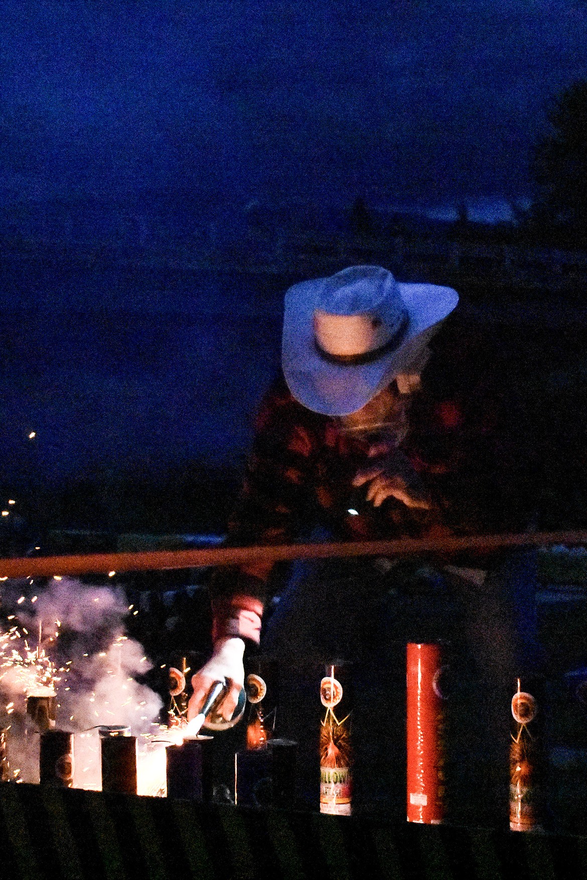 Joe Wade lights the fuses by hand during the annual Fourth of July fireworks display on Saturday, June 30. (Ben Kibbey/The Western News)