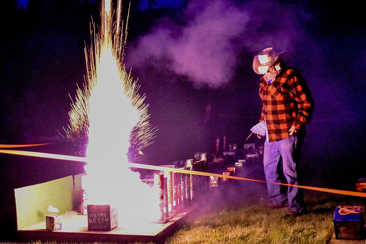 Joe Wade is lit by fireworks during an early Fourth of July event on Saturday. (Ben Kibbey/The Western News)