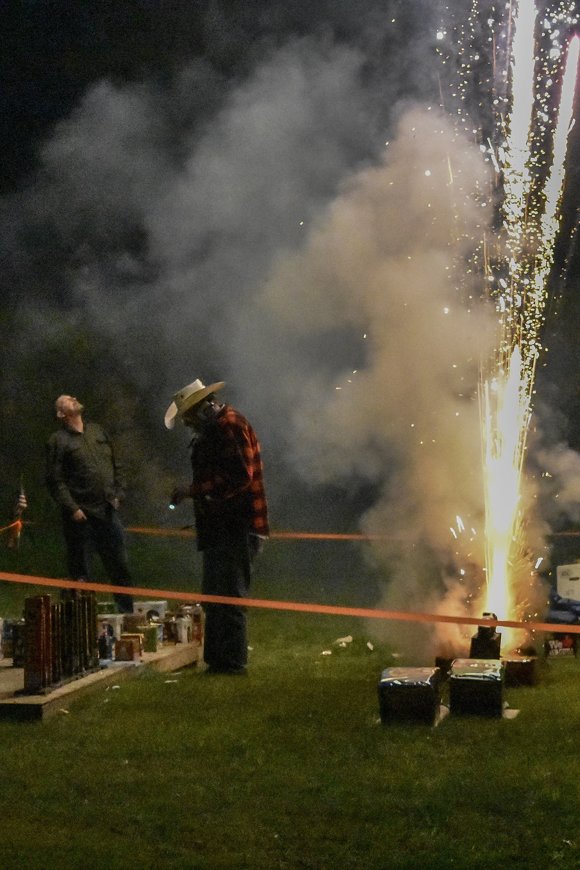 With explosions all around, Joe Wade walked cooly among his fireworks, lighting the fuses during the annual Fourth of July fireworks display on Saturday, June 30. (Ben Kibbey/The Western News)