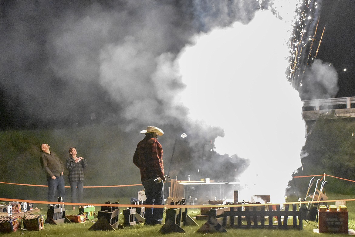 With explosions all around, Joe Wade walked cooly among his fireworks, lighting the fuses during the annual Fourth of July fireworks display on Saturday, June 30. (Ben Kibbey/The Western News)