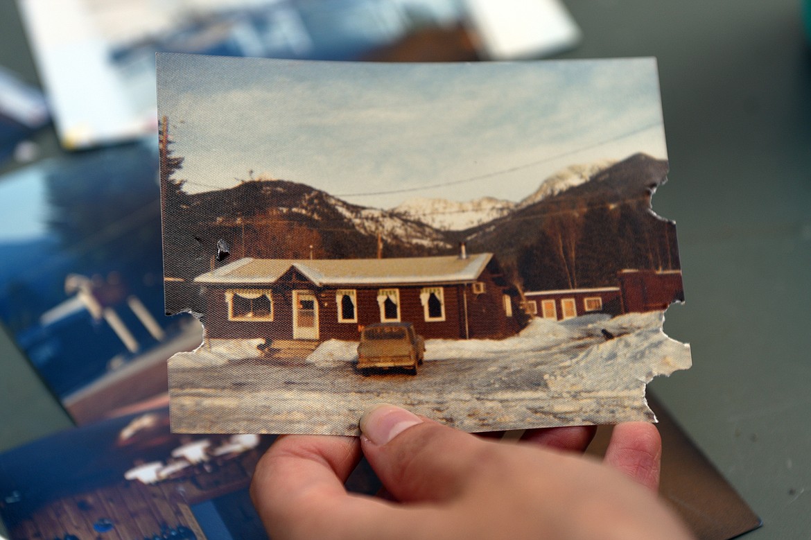 Owner Kathleen Moon displays old photographs taken throughout the years of the Laughing Horse Lodge near Swan Lake. (Casey Kreider/Daily Inter Lake)