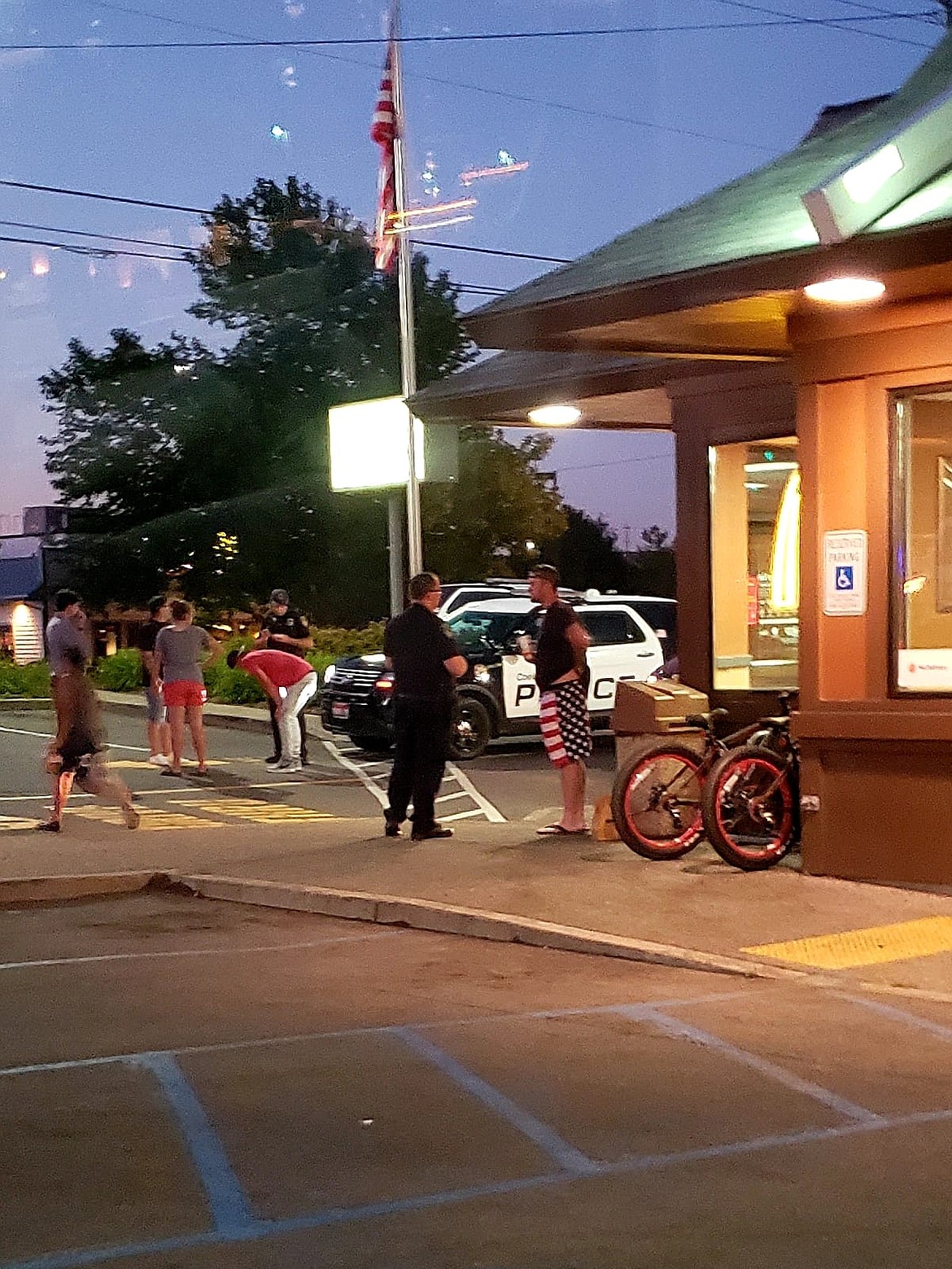 Police question witnesses outside the McDonald's restaurant on Hanley Avenue in Coeur d'Alene on July 12 after an incident that led to the July 17 arrest of Richard Sovenski, of Hayden, who is charged with battery and malicious harassment. (Photo courtesy of Chris Morse)