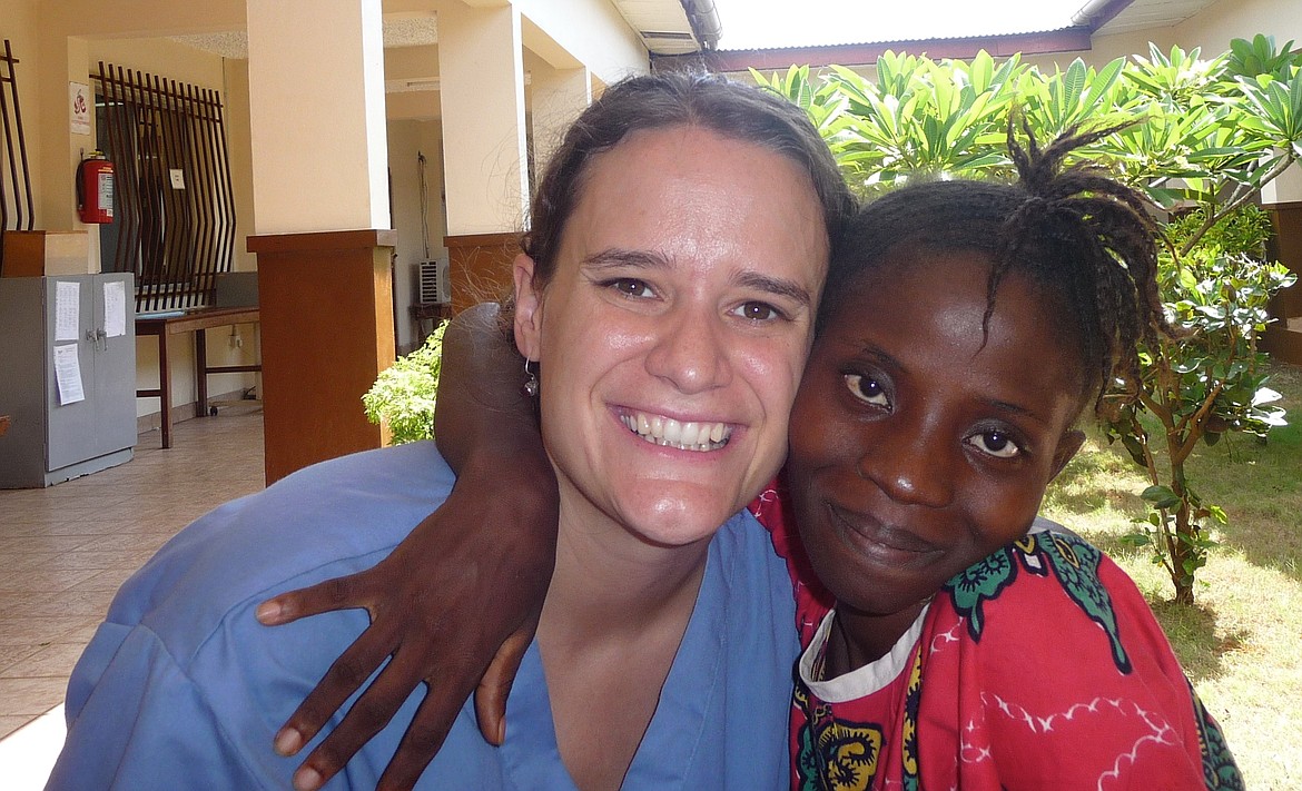 A patient in Sierra Leone gives Sarah Walker a hug.