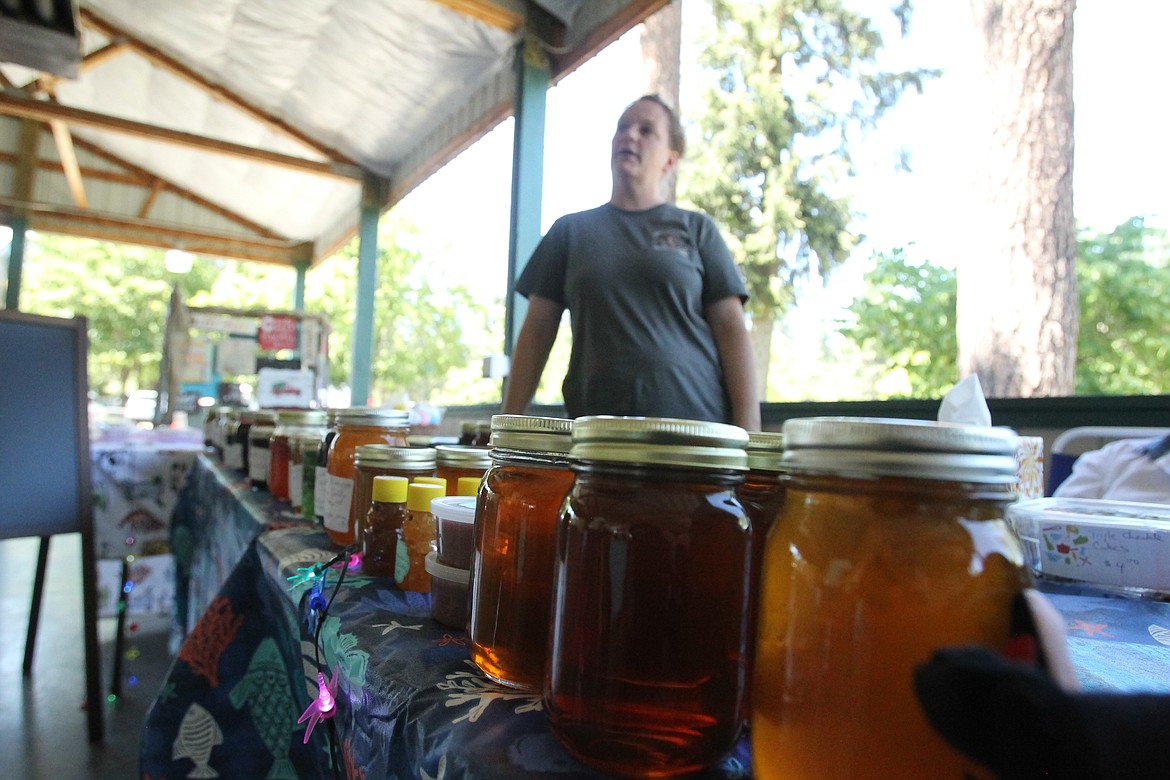 Homemade jams, jellies, pickles and honey harvested in Rose Lake are among Timber Guier's offerings at her &quot;Timber's Tasty Treats&quot; table Saturday during the Post Falls Festival craft fair. Other crafts on display and for purchase included hand-made signs, 3D photography, fiber arts and other unique North Idaho creations. (DEVIN WEEKS/Press)