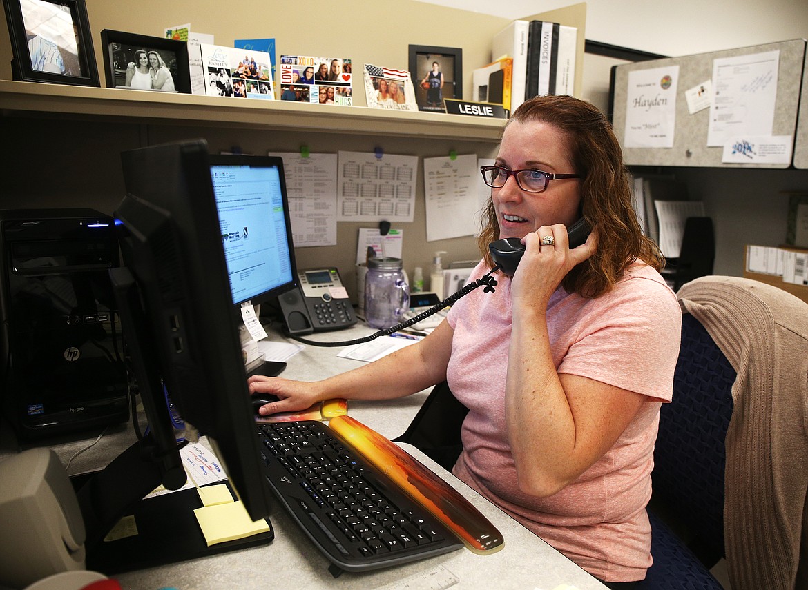 City of Hayden account technician Leslie Shelton talks with a third-party vendor over the phone about a utility bill Friday afternoon at Hayden City Hall.